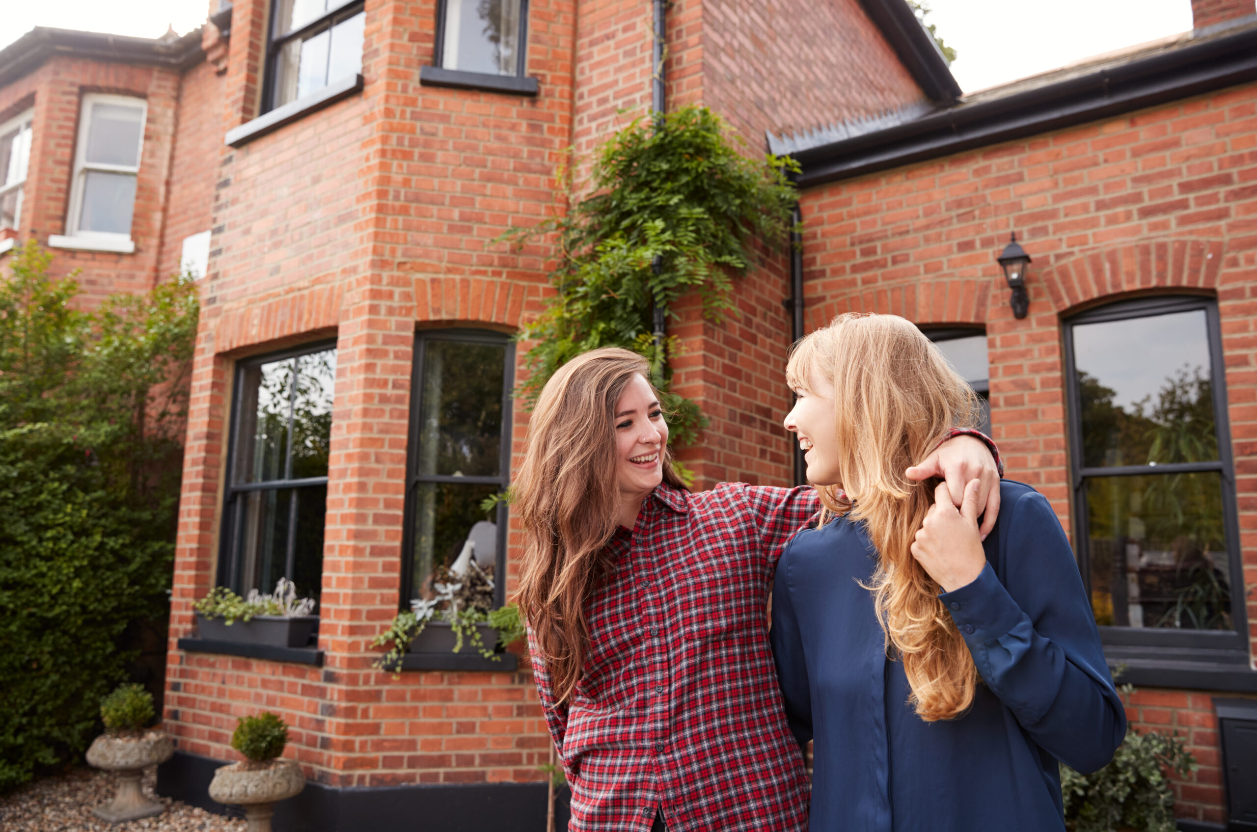 Simplified Property Renting - happy couple outside their new rental house